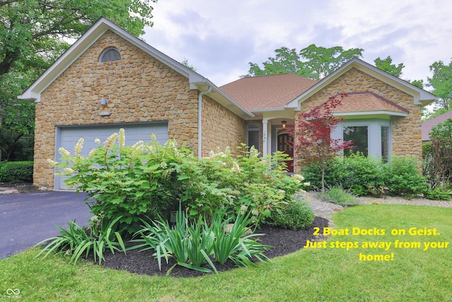 8069 Middle Bay Ln, Indianapolis, IN 46236 - view of front facade with stone siding, driveway, a garage, and roof with shingles