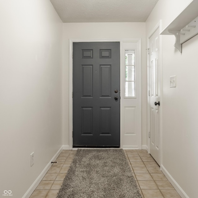 1112 Halifax Ct, Indianapolis, IN 46231 - entrance foyer with light tile patterned floors and a textured ceiling