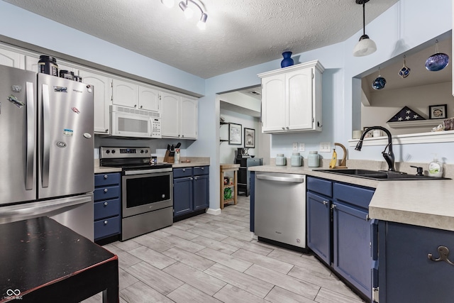 1112 Halifax Ct, Indianapolis, IN 46231 - kitchen with stainless steel appliances, blue cabinetry, light countertops, white cabinetry, and a textured ceiling