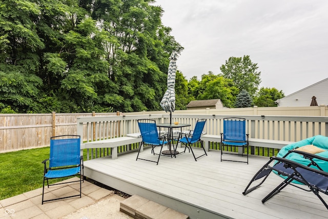 1112 Halifax Ct, Indianapolis, IN 46231 - wooden terrace with outdoor dining area and view of wooded area