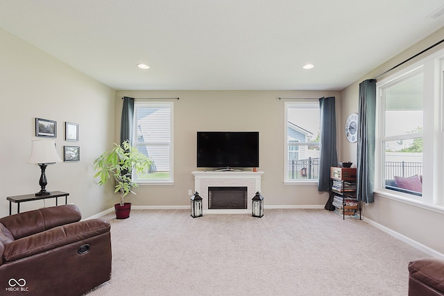 11840 Crossbill Ct, Noblesville, IN 46060 - carpeted living area featuring a fireplace with flush hearth, plenty of natural light, and recessed lighting