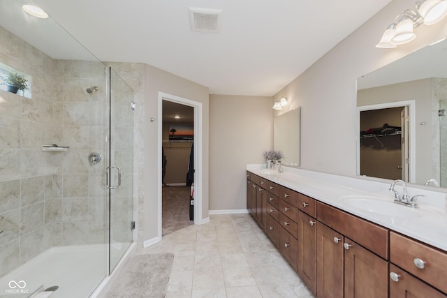 11840 Crossbill Ct, Noblesville, IN 46060 - full bathroom featuring double vanity, a spacious closet, a shower stall, and tile patterned flooring