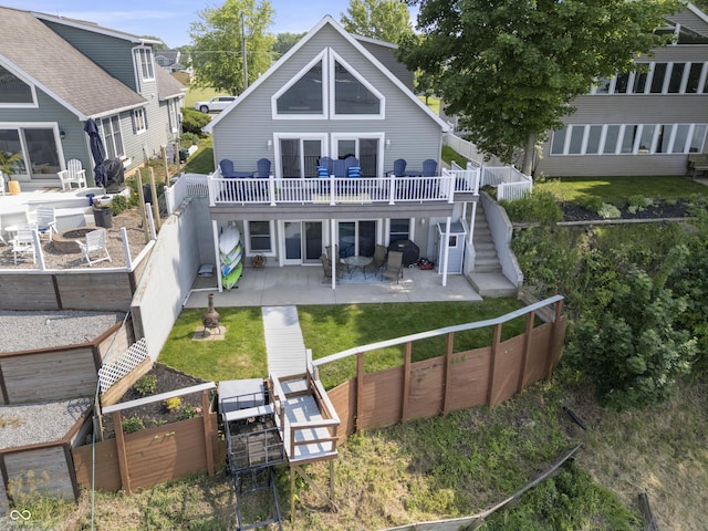 5823 E Sheridan Rd, Monticello, IN 47960 - rear view of house with a patio, stairway, a vegetable garden, a deck, and a fenced backyard