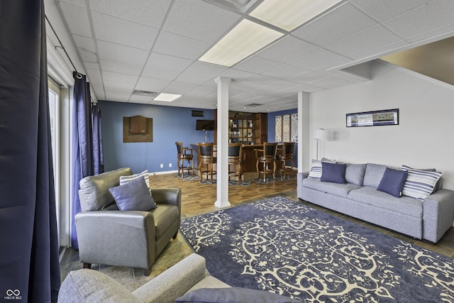 5823 E Sheridan Rd, Monticello, IN 47960 - living room with a bar, a drop ceiling, and wood finished floors