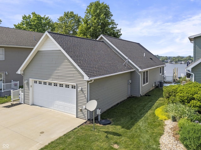 5823 E Sheridan Rd, Monticello, IN 47960 - view of side of home featuring a garage, driveway, a yard, and roof with shingles