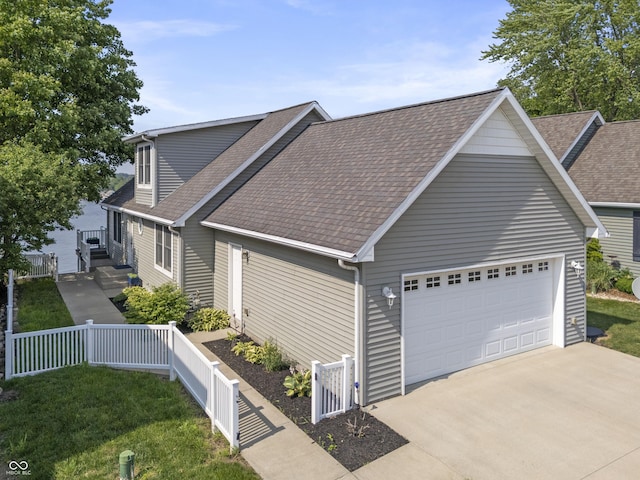 5823 E Sheridan Rd, Monticello, IN 47960 - view of front facade with roof with shingles, concrete driveway, and a garage