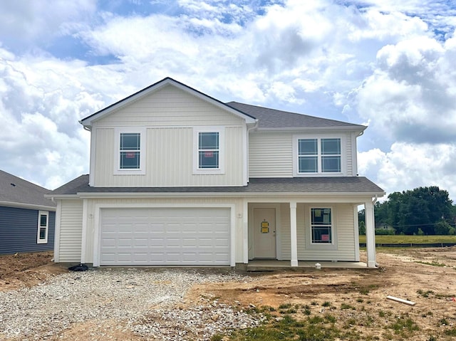 1207 Mcbride St, Greenfield, IN 46140 - view of front of home with an attached garage, gravel driveway, and covered porch