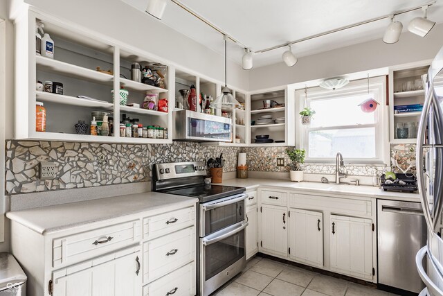 48 Wilson Dr, Carmel, IN 46032 - kitchen with appliances with stainless steel finishes, open shelves, rail lighting, and backsplash