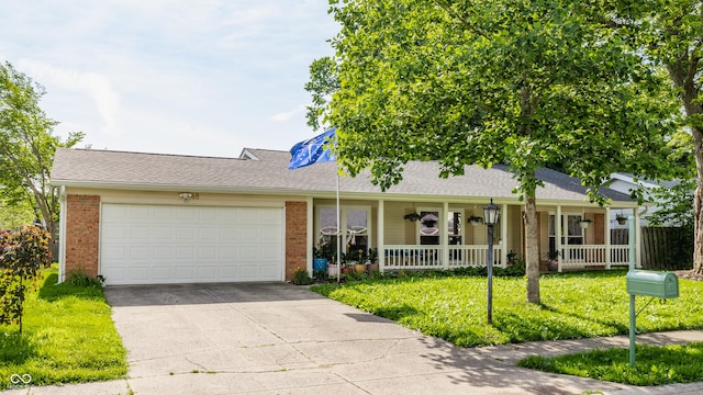 48 Wilson Dr, Carmel, IN 46032 - ranch-style home with brick siding, a porch, concrete driveway, an attached garage, and a front yard