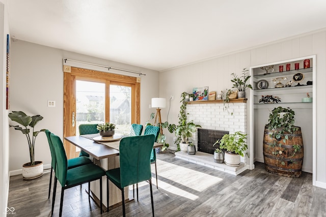 48 Wilson Dr, Carmel, IN 46032 - dining area featuring wood finished floors and a brick fireplace