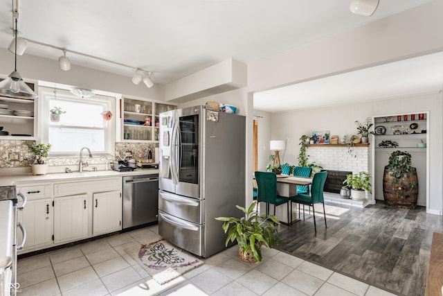 48 Wilson Dr, Carmel, IN 46032 - kitchen featuring stainless steel appliances, decorative backsplash, light countertops, and light tile patterned floors