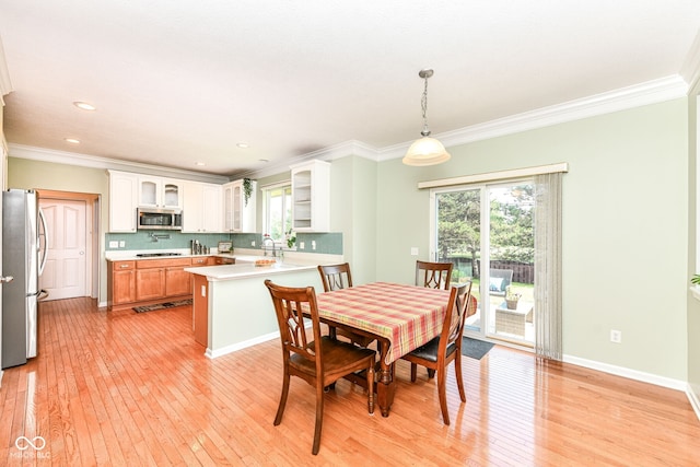 14109 Secretariat Ct, Carmel, IN 46074 - dining area with healthy amount of natural light, light wood finished floors, crown molding, and recessed lighting