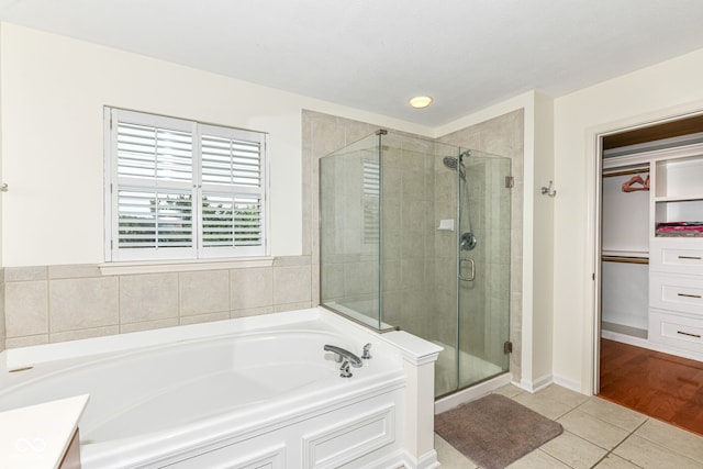 14109 Secretariat Ct, Carmel, IN 46074 - bathroom with tile patterned floors, a bath, a shower stall, and a walk in closet