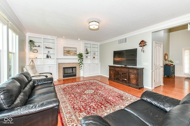 14109 Secretariat Ct, Carmel, IN 46074 - living area featuring wood finished floors, ornamental molding, and a tile fireplace