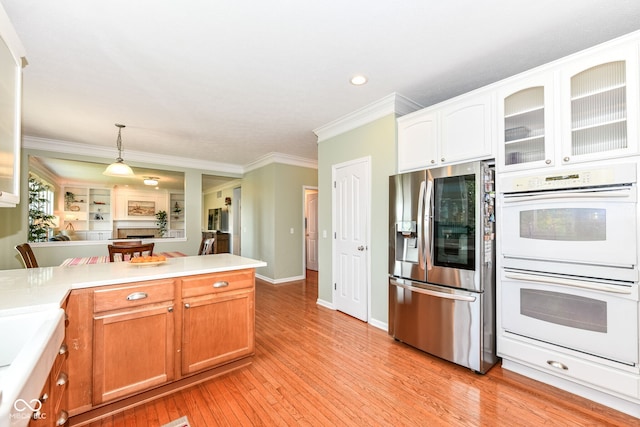 14109 Secretariat Ct, Carmel, IN 46074 - kitchen featuring stainless steel refrigerator with ice dispenser, white double oven, ornamental molding, light wood-type flooring, and glass insert cabinets