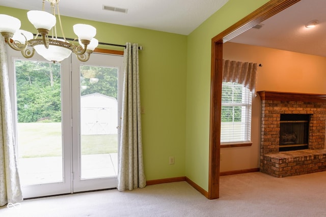 413 Blue Spring Dr, Indianapolis, IN 46239 - unfurnished living room with carpet flooring, a chandelier, plenty of natural light, and a fireplace