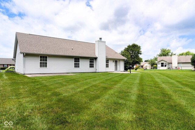 413 Blue Spring Dr, Indianapolis, IN 46239 - back of house featuring a yard, a chimney, and roof with shingles