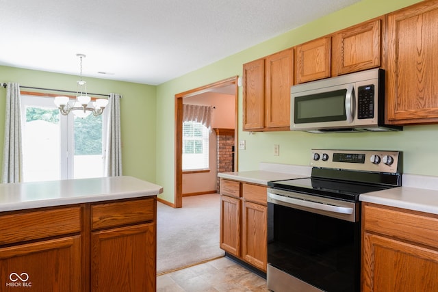 413 Blue Spring Dr, Indianapolis, IN 46239 - kitchen with stainless steel appliances, a chandelier, light countertops, decorative light fixtures, and light colored carpet