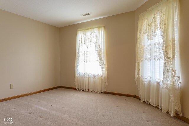 413 Blue Spring Dr, Indianapolis, IN 46239 - unfurnished room with plenty of natural light and light carpet