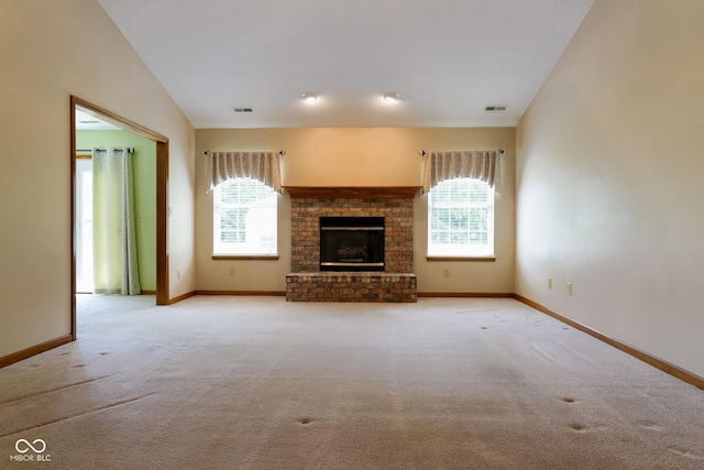 413 Blue Spring Dr, Indianapolis, IN 46239 - unfurnished living room with plenty of natural light, light carpet, and a fireplace