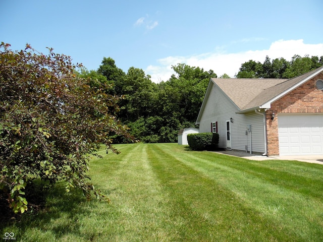413 Blue Spring Dr, Indianapolis, IN 46239 - view of grassy yard with a storage shed and an attached garage