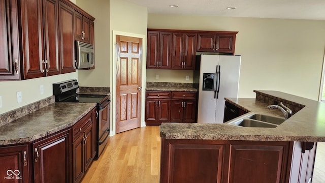 4230 Raintree Blvd, Greenwood, IN 46143 - kitchen featuring stainless steel appliances, dark brown cabinets, light wood-style flooring, dark countertops, and recessed lighting
