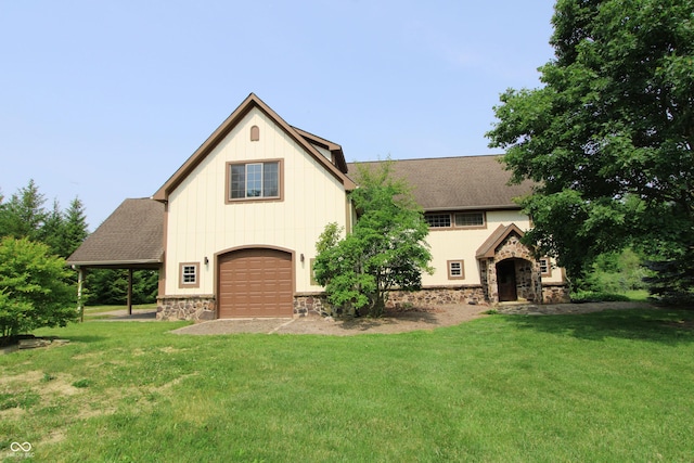 2825 E 216th St, Cicero, IN 46034 - view of front of house featuring stone siding, a front lawn, an attached garage, a shingled roof, and driveway