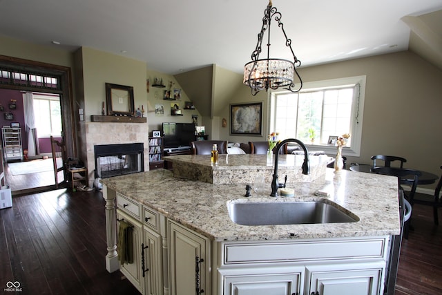 2825 E 216th St, Cicero, IN 46034 - kitchen with dark wood finished floors, open floor plan, a center island with sink, lofted ceiling, and a fireplace