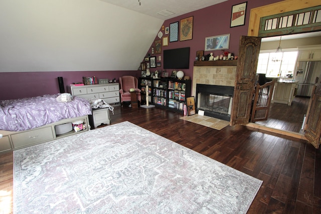 2825 E 216th St, Cicero, IN 46034 - bedroom with stainless steel refrigerator with ice dispenser, wood finished floors, lofted ceiling, and a fireplace