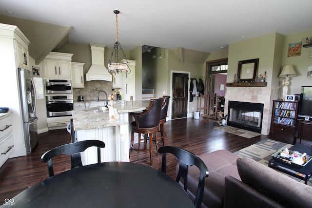 2825 E 216th St, Cicero, IN 46034 - living area with dark wood finished floors, a tiled fireplace, and vaulted ceiling