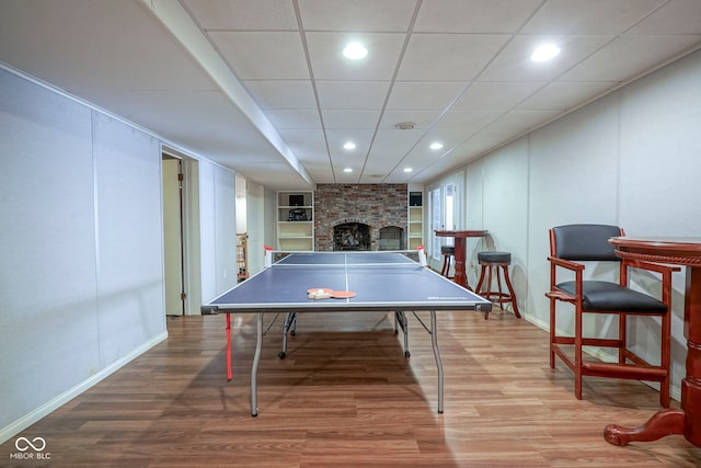 9420 N Kenwood Ave, Indianapolis, IN 46260 - recreation room featuring wood finished floors, a brick fireplace, and recessed lighting