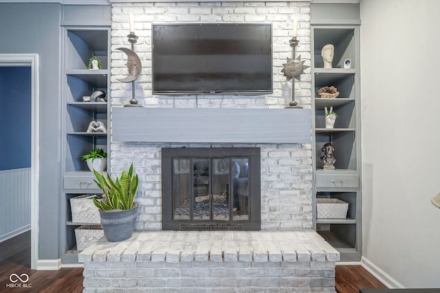 9420 N Kenwood Ave, Indianapolis, IN 46260 - living area with built in shelves, a brick fireplace, and wood finished floors
