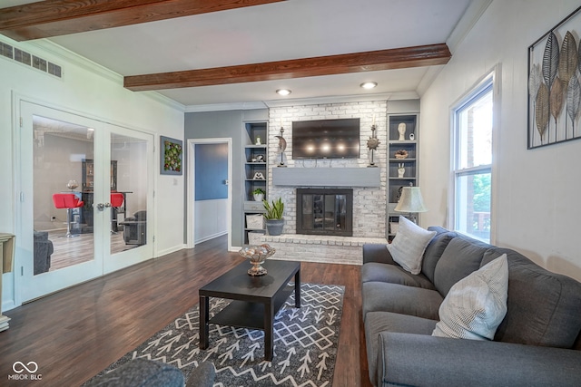 9420 N Kenwood Ave, Indianapolis, IN 46260 - living room with beamed ceiling, dark wood-style flooring, crown molding, french doors, and a brick fireplace