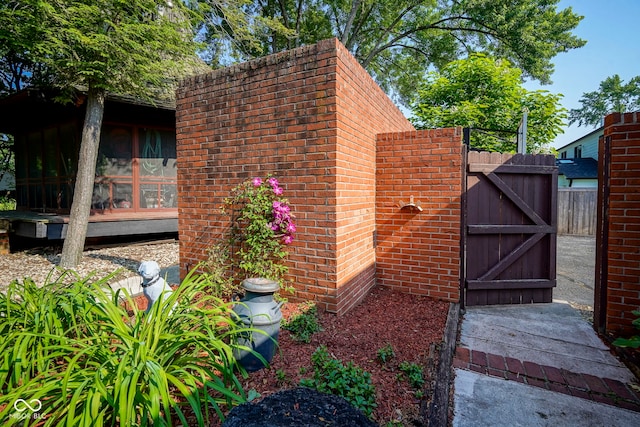 9420 N Kenwood Ave, Indianapolis, IN 46260 - view of home's exterior with a gate and a sunroom