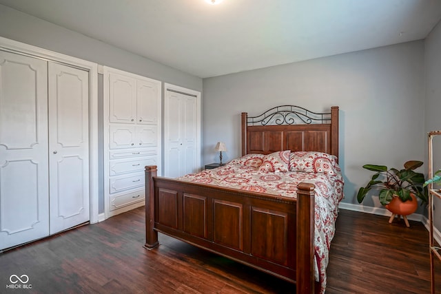 9420 N Kenwood Ave, Indianapolis, IN 46260 - bedroom featuring dark wood-style flooring and two closets