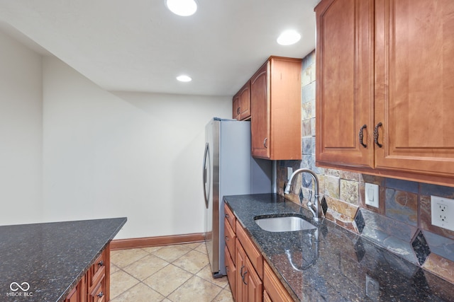 5274 Brooks Bnd, Greenwood, IN 46143 - kitchen with tasteful backsplash, brown cabinetry, dark stone counters, and recessed lighting