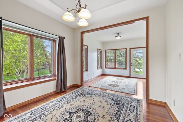 5274 Brooks Bnd, Greenwood, IN 46143 - spare room with healthy amount of natural light, a chandelier, and wood finished floors