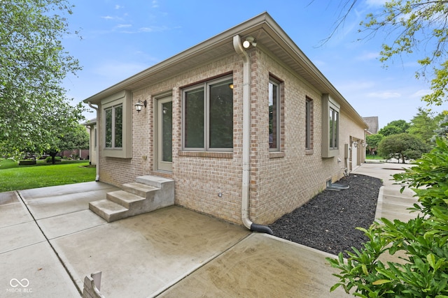 5274 Brooks Bnd, Greenwood, IN 46143 - view of side of property with a patio area, brick siding, entry steps, and a yard