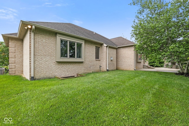 5274 Brooks Bnd, Greenwood, IN 46143 - rear view of house with brick siding, a lawn, a shingled roof, and a patio area