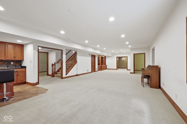 5274 Brooks Bnd, Greenwood, IN 46143 - unfurnished living room featuring recessed lighting, light colored carpet, stairway, and bar area