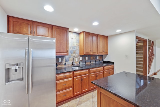 5274 Brooks Bnd, Greenwood, IN 46143 - kitchen featuring stainless steel fridge with ice dispenser, decorative backsplash, dark stone countertops, brown cabinetry, and recessed lighting