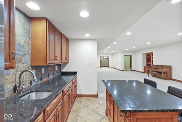 5274 Brooks Bnd, Greenwood, IN 46143 - kitchen with recessed lighting, open floor plan, tasteful backsplash, dark stone countertops, and brown cabinets