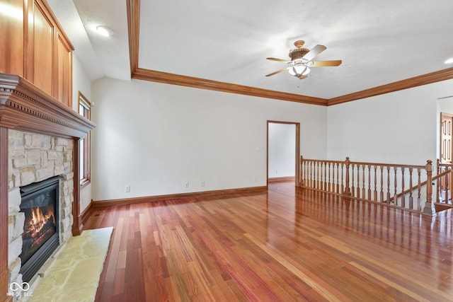 5274 Brooks Bnd, Greenwood, IN 46143 - unfurnished living room with a ceiling fan, wood finished floors, a stone fireplace, and ornamental molding
