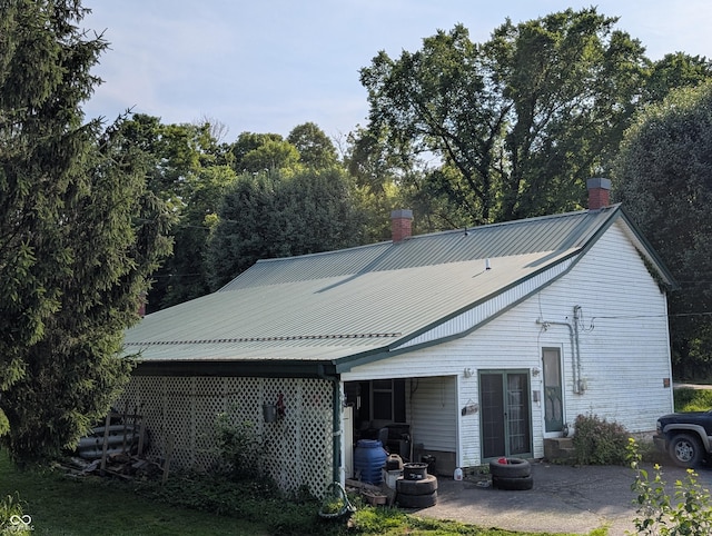 180 N Pike St, Vernon, IN 47282 - rear view of house with a chimney and a metal roof