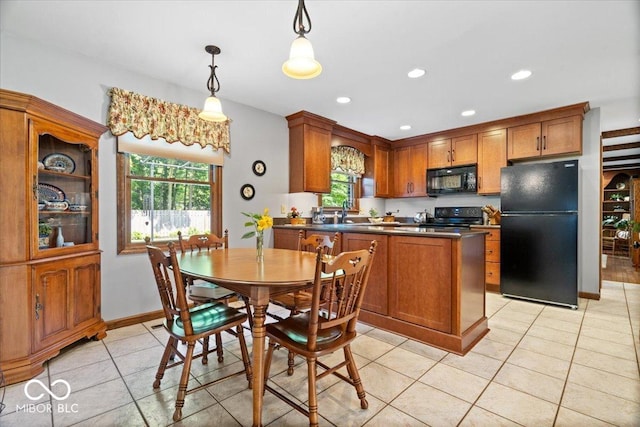 54 Horseshoe Ln, Carmel, IN 46033 - kitchen with black appliances, dark countertops, brown cabinetry, hanging light fixtures, and light tile patterned floors