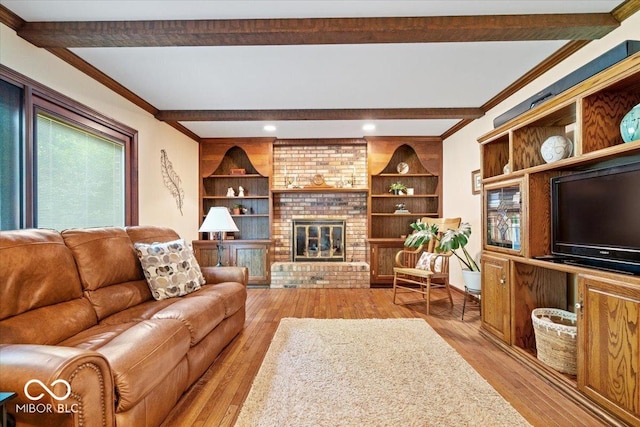 54 Horseshoe Ln, Carmel, IN 46033 - living area featuring beamed ceiling, light wood finished floors, ornamental molding, and a brick fireplace