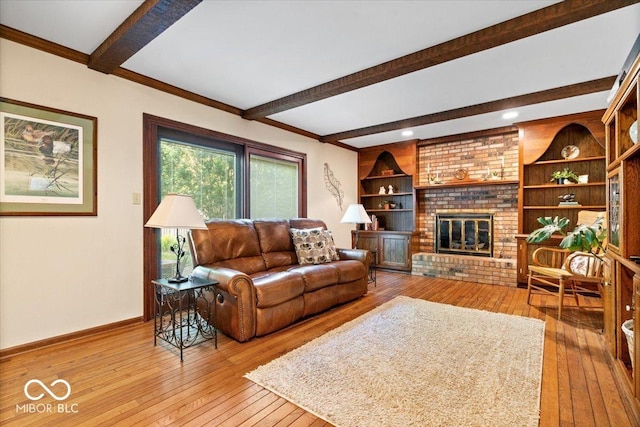 54 Horseshoe Ln, Carmel, IN 46033 - living area featuring wood-type flooring, beam ceiling, and a brick fireplace
