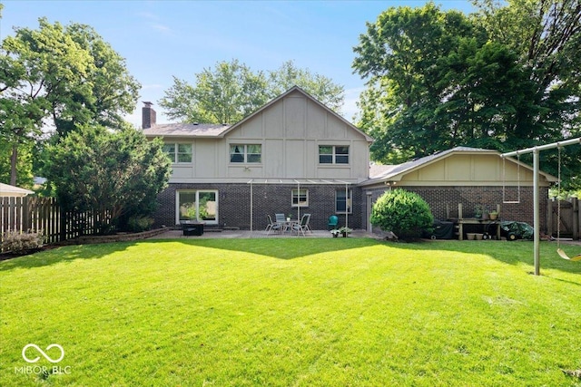 54 Horseshoe Ln, Carmel, IN 46033 - back of house featuring board and batten siding, a chimney, a patio area, and brick siding
