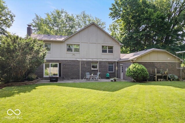 54 Horseshoe Ln, Carmel, IN 46033 - rear view of property with a patio, a lawn, a chimney, brick siding, and board and batten siding
