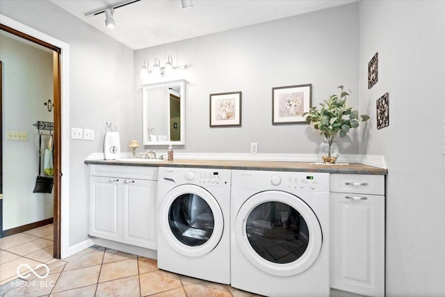 54 Horseshoe Ln, Carmel, IN 46033 - laundry room featuring washing machine and clothes dryer, rail lighting, cabinet space, and light tile patterned flooring